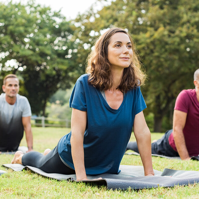 Mature,Healthy,People,Doing,Yoga,At,Park.,Group,Of,Multiethnic